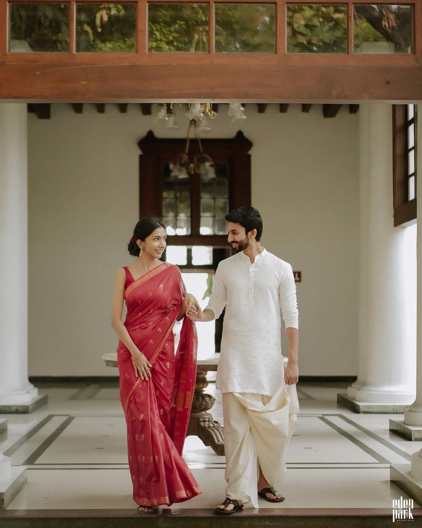 A couple walking together in traditional wedding attire