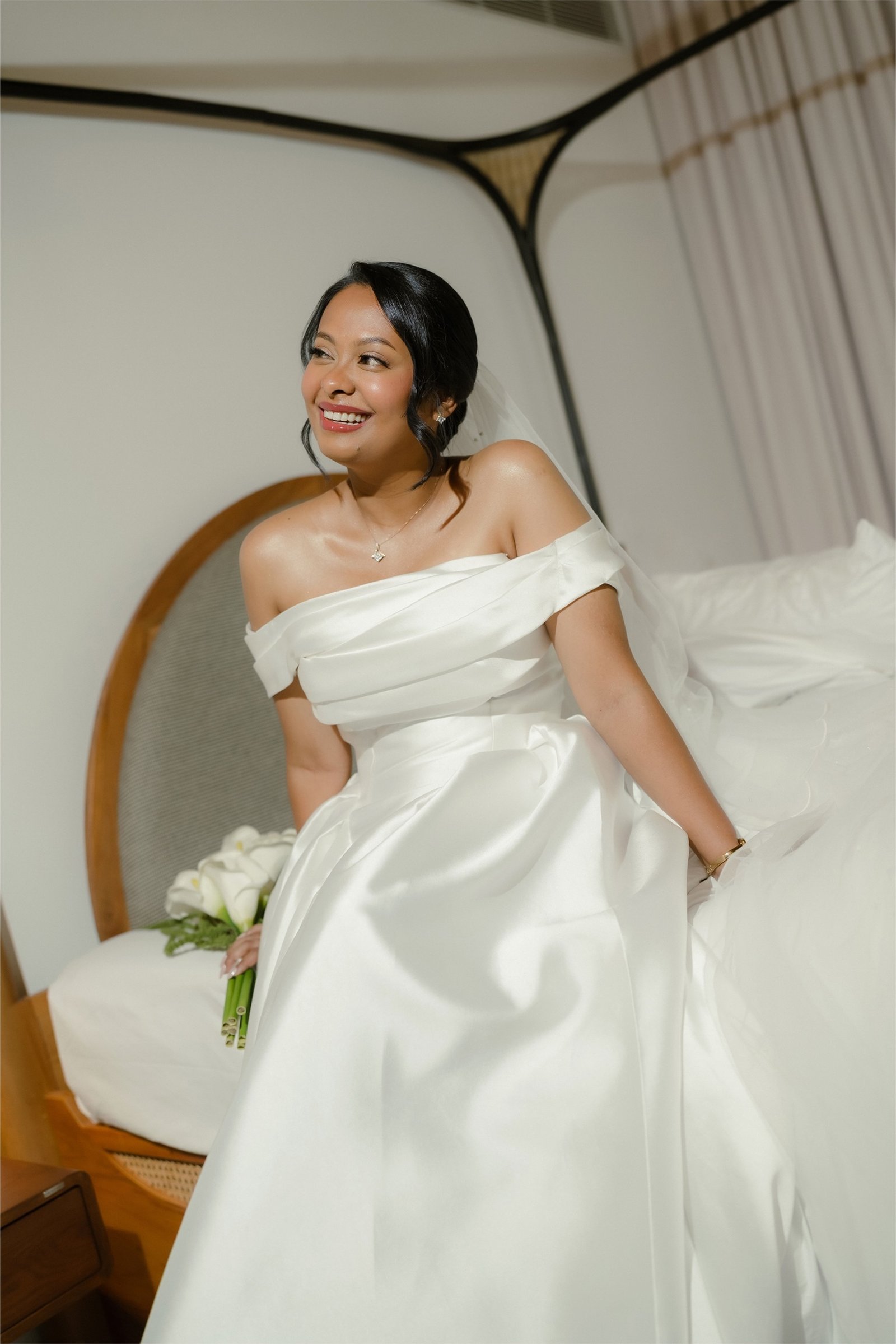 A bride smiling in her wedding dress