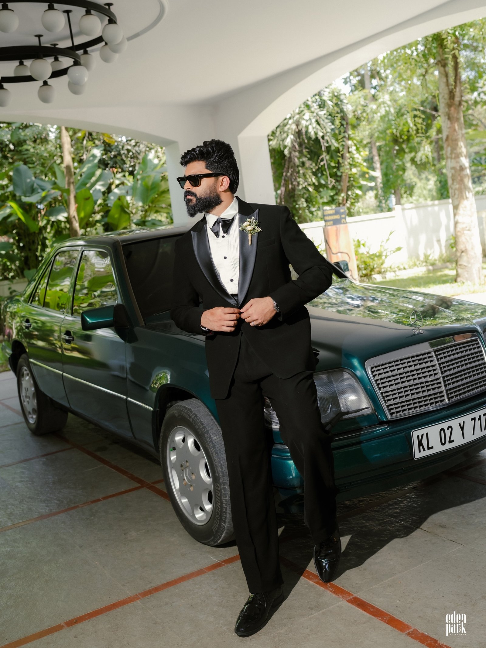 A groom standing beside a car